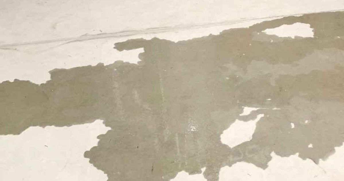 Slab leak shown by water on a concrete floor