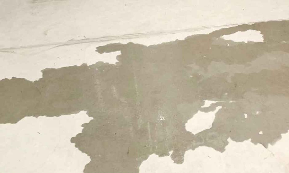 Slab leak shown by water on a concrete floor